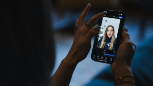 Woman's hands editing a short-form video on a smartphone