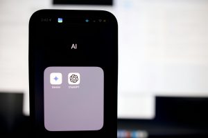 iPhone screen showing AI apps folder containing Gemini and ChatGPT