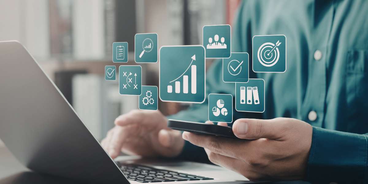Man on laptop and phone with data and analytics icons