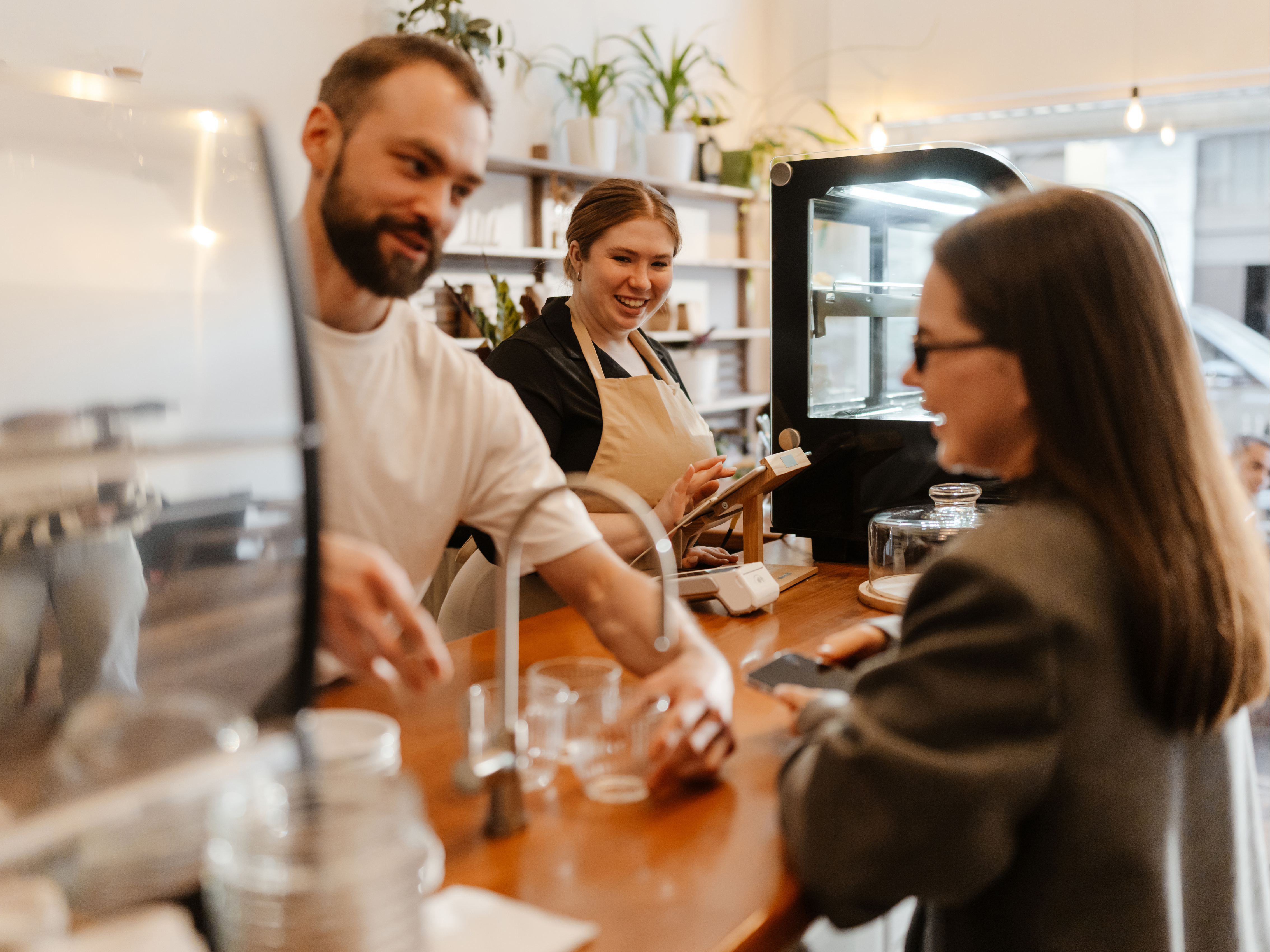 coffee shop owner serving customers